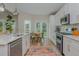 Bright kitchen features stainless appliances, white cabinetry, and a sunny breakfast nook overlooking the backyard at 2045 Bethany Spring Trce, Cumming, GA 30041