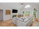 Comfortable living room with a stone fireplace and large windows offering ample natural light at 2045 Bethany Spring Trce, Cumming, GA 30041