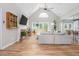 Bright living room with wood floors, a stone fireplace, and an open layout at 2045 Bethany Spring Trce, Cumming, GA 30041