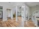 Open-concept living area with stylish wood flooring, white columns, and ample natural light at 2045 Bethany Spring Trce, Cumming, GA 30041