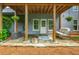 Cozy patio with stone floor, outdoor seating, and hanging plants for relaxing outdoor living at 2045 Bethany Spring Trce, Cumming, GA 30041
