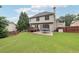 A back exterior featuring the home's deck and patio and a trampoline in the fenced yard at 402 Homestead Dr, Dallas, GA 30157