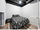 Basement bedroom featuring vinyl floor, painted ceiling, bed, dresser, and walk-in closet at 402 Homestead Dr, Dallas, GA 30157