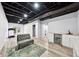 Finished basement with vinyl flooring, painted ceiling, and space for entertaining and exercising at 402 Homestead Dr, Dallas, GA 30157