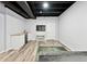 Finished basement with vinyl flooring, painted ceiling, kitchenette, and space for entertaining at 402 Homestead Dr, Dallas, GA 30157