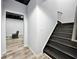 Basement staircase leading to a finished basement space with vinyl flooring and painted ceiling at 402 Homestead Dr, Dallas, GA 30157