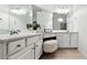 Bright bathroom featuring double sinks, tile floor, and a vanity table with stool at 402 Homestead Dr, Dallas, GA 30157