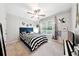 This bedroom features natural lighting, a ceiling fan, and stylish decor to offer a comfortable personal space at 402 Homestead Dr, Dallas, GA 30157