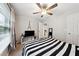 Inviting bedroom boasts natural light, a ceiling fan, and stylish decor for a relaxing and comfortable ambiance at 402 Homestead Dr, Dallas, GA 30157