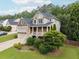 Two-story home with a stone facade, covered porch, and well-maintained landscaping at 402 Homestead Dr, Dallas, GA 30157