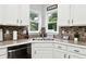 Kitchen with decorative tile backsplash, stainless steel dishwasher, and double bowl sink at 402 Homestead Dr, Dallas, GA 30157