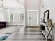 The home's entry featuring new flooring with views to the living room with large windows at 402 Homestead Dr, Dallas, GA 30157