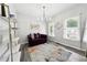 Bright living area featuring a modern chandelier, plush seating, and ample natural light at 402 Homestead Dr, Dallas, GA 30157