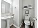 Stylish powder room featuring modern fixtures, including a pedestal sink and decorative accents at 402 Homestead Dr, Dallas, GA 30157