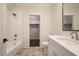 This bathroom features a tub with subway tile and a white vanity with a view to a walk in closet at 11 Brownson Ct, Acworth, GA 30101