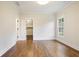 Bright bedroom features hardwood floors, crown molding, closet and a window looking out onto a lush green landscape at 11 Brownson Ct, Acworth, GA 30101