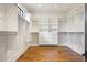 Large walk-in closet with built-in shelving and hardwood flooring at 11 Brownson Ct, Acworth, GA 30101