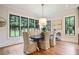 Bright dining room with large windows, hardwood floors, and stylish lighting at 11 Brownson Ct, Acworth, GA 30101