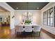 Elegant dining room with stylish light fixture and an open view to the living area and backyard at 11 Brownson Ct, Acworth, GA 30101