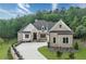 Charming brick and shingle home with well-manicured lawn, long driveway, and lush landscaping at 11 Brownson Ct, Acworth, GA 30101