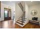 Elegant foyer featuring hardwood floors, staircase with iron railing and bench seating at 11 Brownson Ct, Acworth, GA 30101