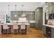 Modern kitchen featuring an island, pendant lighting, custom cabinets, and hardwood floors at 11 Brownson Ct, Acworth, GA 30101