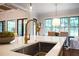 Kitchen island with stainless steel sink, gold faucet, white countertop, and pendant lighting at 11 Brownson Ct, Acworth, GA 30101
