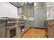Modern kitchen with stainless steel appliances, custom cabinets, and hardwood floors at 11 Brownson Ct, Acworth, GA 30101