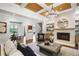 Open-concept living room with coffered ceilings, fireplace, and staircase, seamlessly connecting to the dining area at 11 Brownson Ct, Acworth, GA 30101