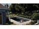 Modern pool with tanning ledge, surrounded by lush landscaping in backyard at 11 Brownson Ct, Acworth, GA 30101
