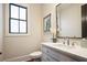 Powder room with modern fixtures, mirror, and natural light at 11 Brownson Ct, Acworth, GA 30101