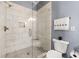 Elegant bathroom featuring a tiled shower with glass door and modern fixtures at 2300 Peachford Rd # 2404, Atlanta, GA 30338