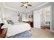 Well-lit bedroom with an adjacent balcony, cozy bed, and en-suite bathroom, perfect for unwinding and relaxing at 2300 Peachford Rd # 2404, Atlanta, GA 30338