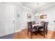 Charming dining area featuring wainscoting, hardwood floors, and an elegant chandelier at 2300 Peachford Rd # 2404, Atlanta, GA 30338