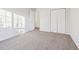 Cozy bedroom featuring neutral carpet and bright natural light from the windows at 245 London Ln, Hiram, GA 30141