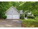 Charming home with two-car garage, mature trees, and well-maintained landscaping at 245 London Ln, Hiram, GA 30141