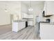 Open kitchen features white cabinets, granite counters, stainless appliances and a breakfast bar at 245 London Ln, Hiram, GA 30141
