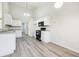 Bright kitchen features white cabinets, stainless steel appliances, and grey laminate flooring at 245 London Ln, Hiram, GA 30141