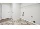 Laundry room with tile floor, white walls and access door at 245 London Ln, Hiram, GA 30141