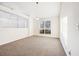 Bright living room with neutral walls, large window, and plush carpet at 245 London Ln, Hiram, GA 30141