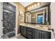 Well-maintained bathroom featuring double sinks, large mirror, and shower with decorative curtain at 360 Glade Knoll Trail Trl, Fayetteville, GA 30215