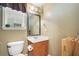Powder room featuring a decorative mirror, wood accents, and neutral tones at 360 Glade Knoll Trail Trl, Fayetteville, GA 30215