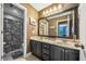 Double vanity in a bathroom with decorative mirror and framed shower curtain at 360 Glade Knoll Trail Trl, Fayetteville, GA 30215