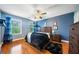 Cozy bedroom featuring hardwood floors, natural light, and stylish decor at 360 Glade Knoll Trail Trl, Fayetteville, GA 30215