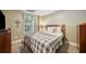 Cozy bedroom featuring soft lighting, neutral tones, and a plaid patterned bedspread at 360 Glade Knoll Trail Trl, Fayetteville, GA 30215