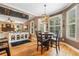 Sunlit dining area with hardwood floors, stylish light fixture, and an open view of the living room at 360 Glade Knoll Trail Trl, Fayetteville, GA 30215