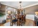 Dining room featuring hardwood floors, neutral walls, and seating for six near an open floor plan at 360 Glade Knoll Trail Trl, Fayetteville, GA 30215