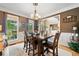 Bright dining room with hardwood floors, neutral walls, and large windows overlooking the yard at 360 Glade Knoll Trail Trl, Fayetteville, GA 30215