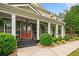 Inviting front porch with stone accents, classic columns, and a vibrant red front door at 360 Glade Knoll Trail Trl, Fayetteville, GA 30215