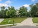Charming two-story home with a manicured front lawn and a long driveway at 360 Glade Knoll Trail Trl, Fayetteville, GA 30215